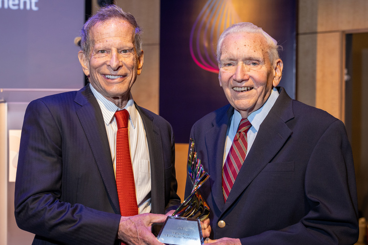 Richard Merkin and F. William Studier stand next to each other in the Broad Institute auditorium holding the Merkin Prize trophy. Richard Merkin and F. William Studier stand next to each other in the Broad Institute auditorium holding the Merkin Prize trophy.